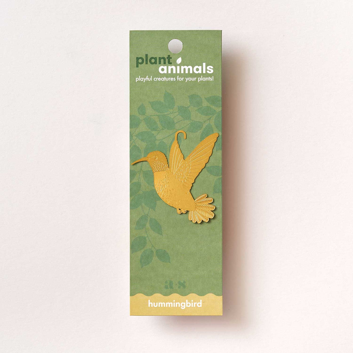 Little brass hummingbird designed to hang on houseplants, a charming gift for plant lovers, available for purchase from The Petal and Plant Company