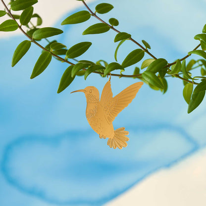 Brass hummingbird plant animal hanging from a plant, looking as if it is flying adding a playful touch to houseplants, a perfect gift for plant enthusiasts, available for purchase from The Petal and Plant Company.