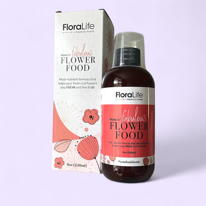 One box of Floralife flower care food with the bottle of flower food displayed from inside the box, set against a purple background, highlighting flower care essentials for sale.