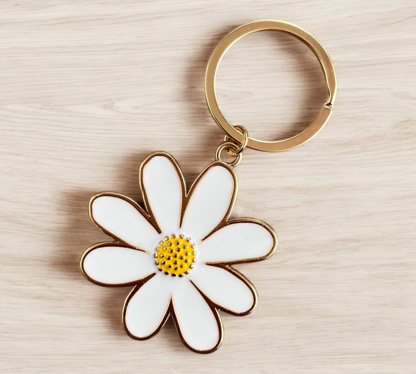 Keyring featuring a charming enamel daisy design, a perfect gift or accessory, available for purchase from The Petal and Plant Company
