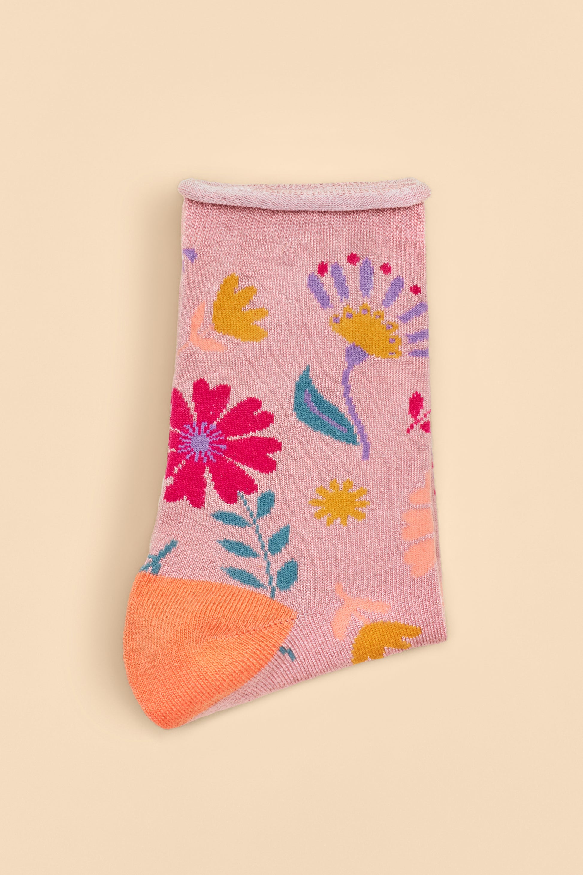 Watercolour Flowers Ankle Socks in a pink base with orange heels and toes, featuring a blue, pink, yellow, and purple floral design, available as a stylish gift from The Petal and Plant Company