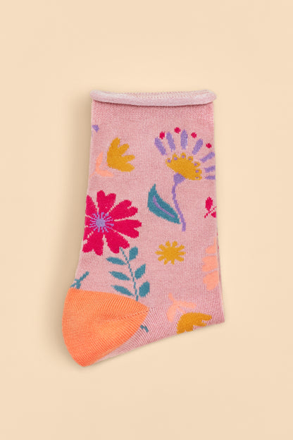 Watercolour Flowers Ankle Socks in a pink base with orange heels and toes, featuring a blue, pink, yellow, and purple floral design, available as a stylish gift from The Petal and Plant Company