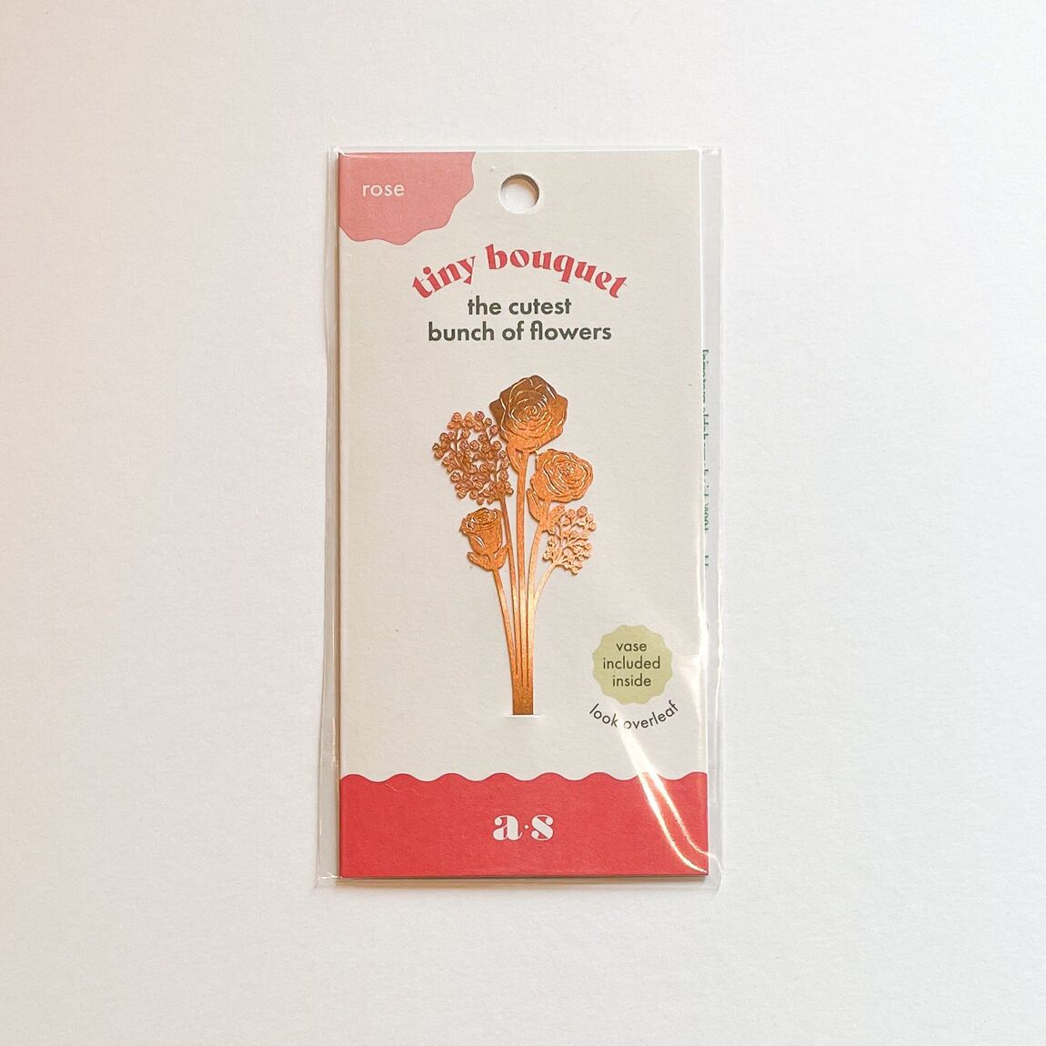 Tiny bouquet of brass roses beautifully arranged in their display packaging, a charming and unique gift available for purchase from The Petal and Plant Company.