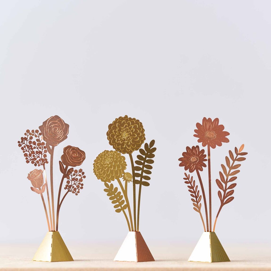 An assortment of tiny bouquets in various designs and materials, displayed standing upright, showcasing the  selection available for purchase from The Petal and Plant Company